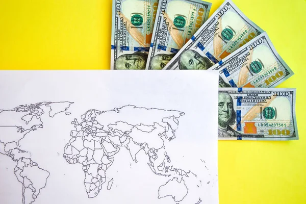 Pile of dollars near USA on world map, money, dollar and world map view from above. Text field, Copy space, US dollar banknotes on globe world map