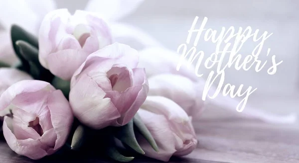 Happy Mothers Day words. Beautiful and tender bouquet of flowers in the hat box, nice present concept, banner size, Greeting card trendy monochrome backdrop. Web banner, Holiday graphic for mom