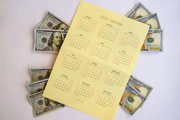 Financial Planning, calendar 2020 with pen and us 100 dollar, Money on a calendar concepts of financial planning, Dollar banknotes