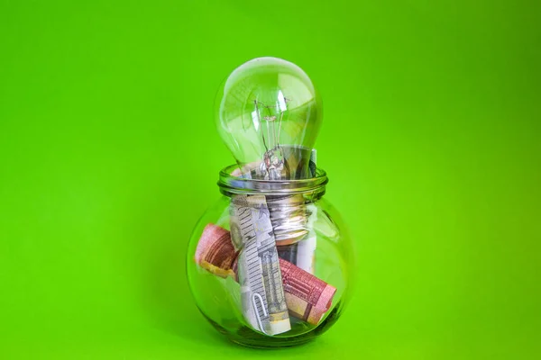 Money saved in different kinds of light bulbs, Lamps on the euro background, Energy saving lamp, money, finance, savings concept and idea