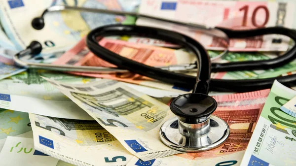 stethoscope and the euro banknotes, Medical cost concept - Stethoscope on euro paper money bank notes Euro banknotes background : Banking Account, Investment Analytic research data economy, trading, Business company concept.