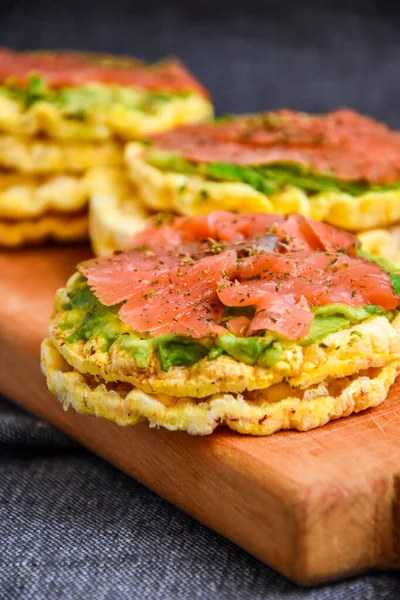 Snacks from rice cookies, salmon, avocado and spices on cutting board, Healthy snack , Breakfast, Vegetarian food, Dieting, gluten free bread, guacamole