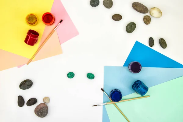 Painting a rock green turtle on a stone step by step. Children art project. DIY concept. Step by step photo instruction.View from above. Work with children and adults in quarantine. Step 5