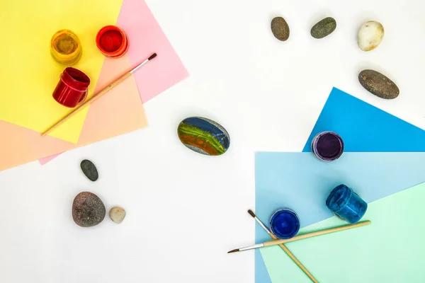 How to draw a rainbow on a stone step by step. Children art project. DIY concept. Step by step photo instruction.View from above. Work with children and adults in quarantine