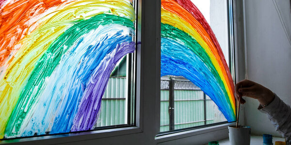 hand painting rainbow on a window, stay home during quarantine, Image of kids leisure at home, Chase the rainbow flashmob