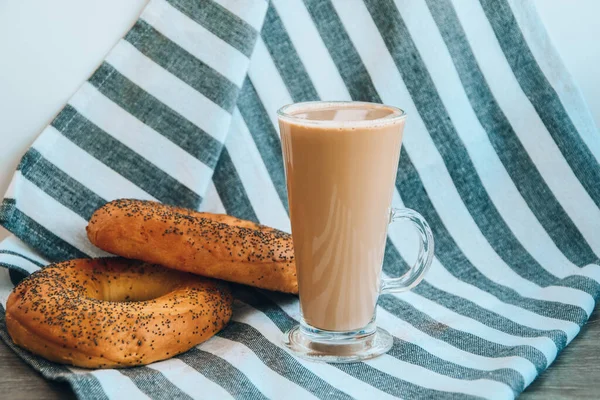 Fresh homemade Poppy bagels bread with cup of coffee, latte machiato or cocoa, cappuccino, breakfast time, Crispy crunchy bagel simits, hot brewed cup of coffee, Traditional Turkish cuisine culture breakfast ingredients