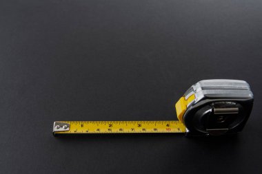 Siyah zemin üzerinde sarı bant ölçüsü olan frakometre ya da metre gümüş rengi