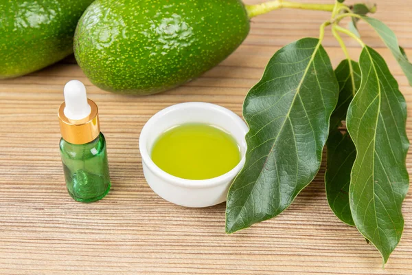 Cosmetic avocado oil in dropper bottle, mock up. Glass bottle. Avocado and olive oil mock up. Natural bio skin care cosmetic. Avocado Essential Oil  dropper mock up.