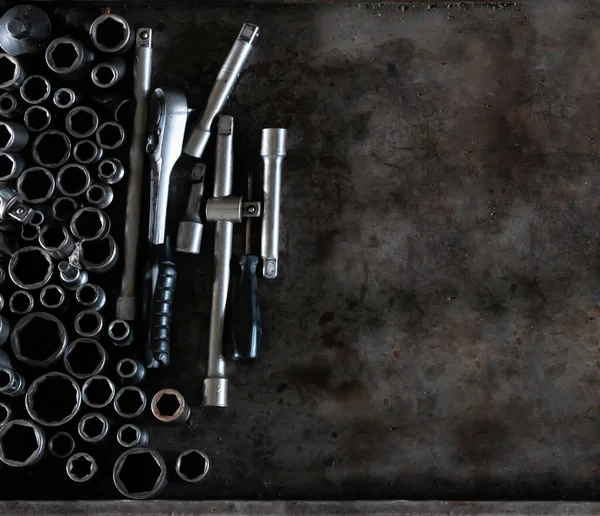 Mechanic tools set on metal background. Vintage style image of blank space on metal, lot of old tools. Copy space. Car service and repair concept. Tools on working table.