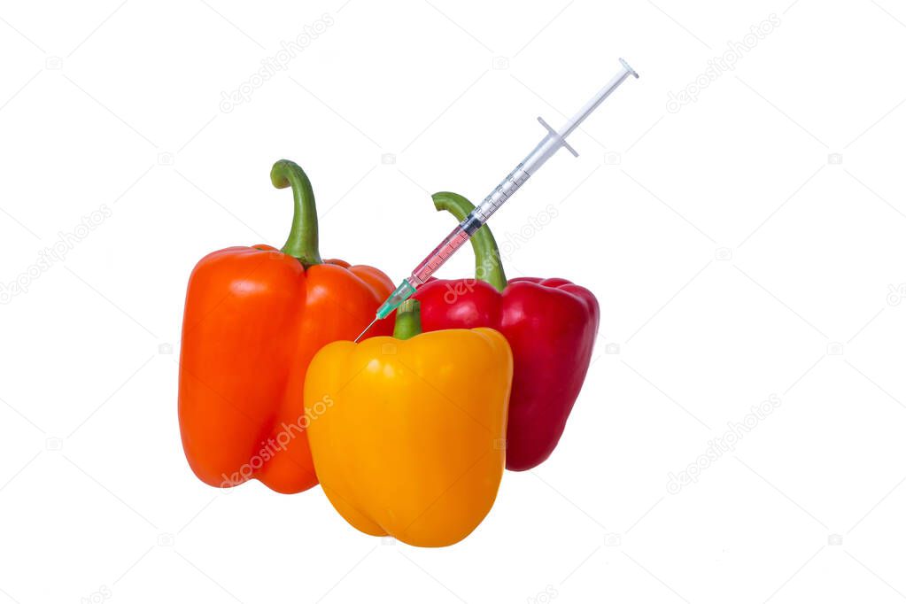 Genetically modified vegetables. GMO food concept. Syringes are stuck in vegetables with chemical additives. Injections into fruits and vegetables. Isolated on white background. 