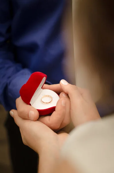 Young man makes a proposal to get married. Man hold marriage ring.love, engagement and holiday concept