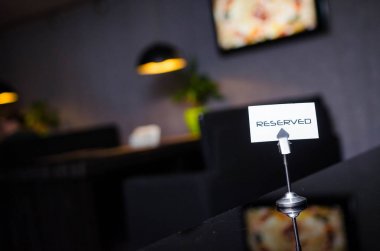 Reserved sign on a table in restaurant. clipart