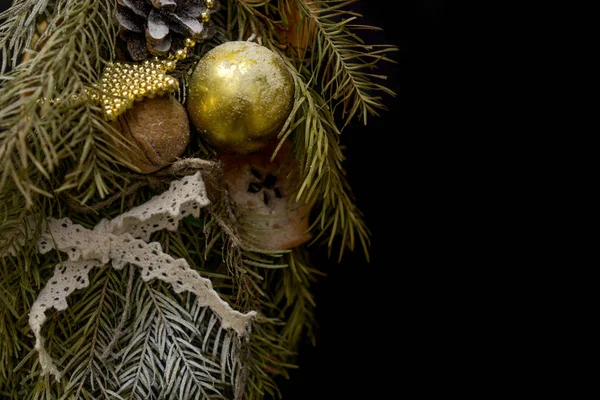 Part of Christmas wreath on black background.