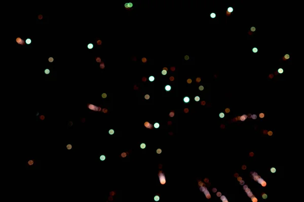 Colorful blurred lights on black. Firework.