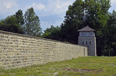 Mauthausen, Austria - July 18, 2018: concentration camp Mauthausen, Holocaust memorial from WWII in Upper Austria, observation tower and barbed wired wall