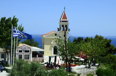 Zakynthos, Greece - May 26, 2016: Unidentified people in restaurant and church Zoodochos Pigi on hill over Zakynthos town
