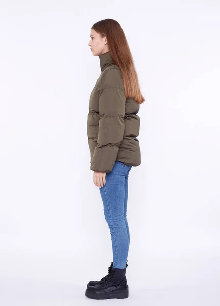 Young girl in a khaki down jacket isolated on a white background. — Stock Photo, Image