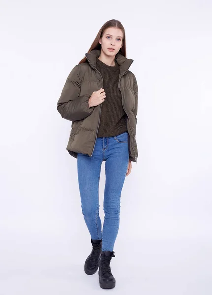 Young girl in a khaki down jacket isolated on a white background. — Stock Photo, Image