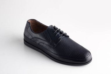 Beyaz arka planda ayakkabı bağcığı olan siyah adam deri ayakkabısı.