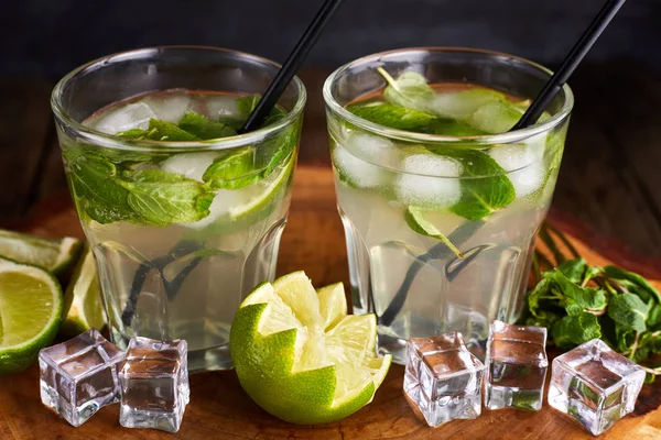 Fresh mojito in glasses with ice cubes on wooden table. — 스톡 사진