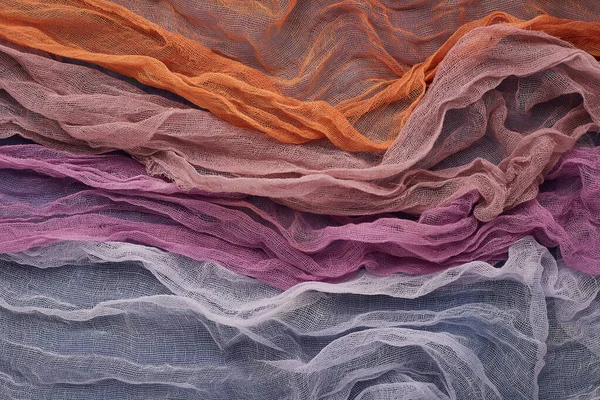 Background from blue,orange, pastel, pink and purple gauze fabric