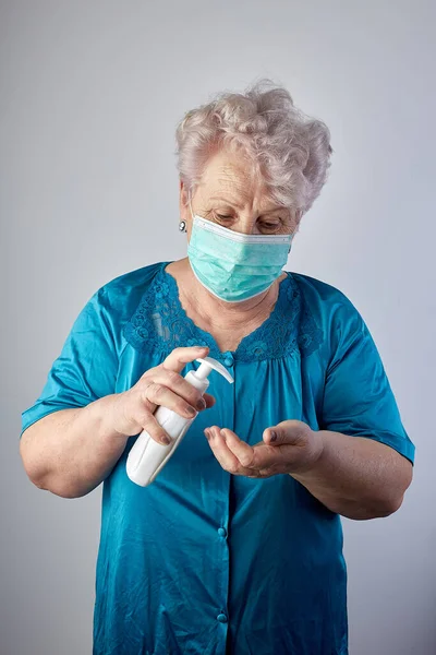 Senior woman hands using wash hand sanitizer gel pump dispenser, Old Asian Woman Washing hand with Alcohol Sanitizer, prevent the virus and bacterias,Hygiene concept.