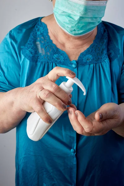 Senior woman hands using wash hand sanitizer gel pump dispenser, Old Asian Woman Washing hand with Alcohol Sanitizer, prevent the virus and bacterias,Hygiene concept.