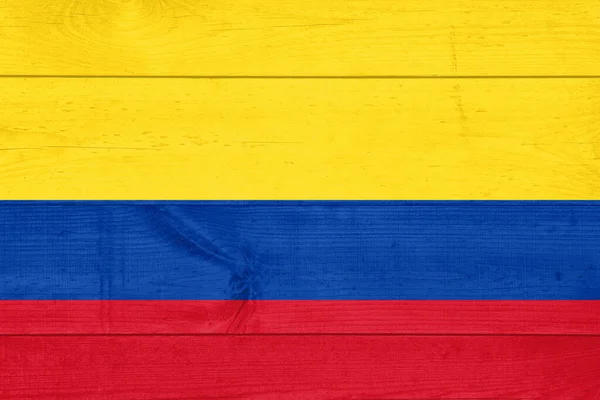 Bandeira da Colômbia pintada sobre fundo prancha de madeira grungy — Fotografia de Stock