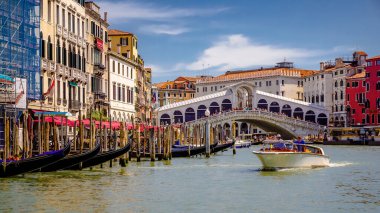 VENICE, VENETO - ITALY - JULY 16 2018: Venice Rialto Bridge view from Grand canal, Italy during a nice hot summer day