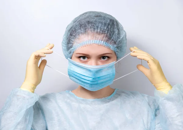 Young Handsome Doctor Medical Uniform Puts Medical Mask Copy Space — Stock Photo, Image