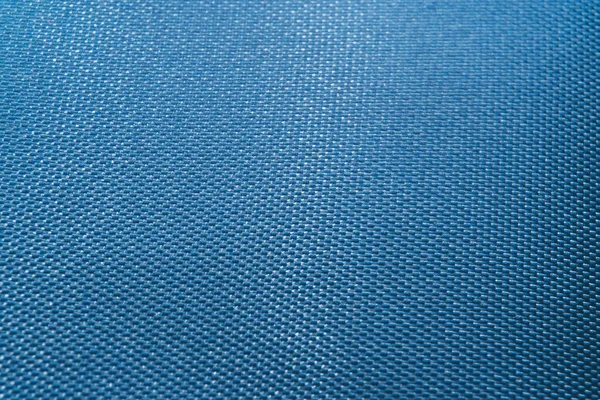 Close-up of abstract flat blue high detail textured clothing fabric pattern background in partial focus and realistic light reflections — Stock Photo, Image