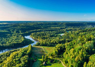 Aerial sight of warm, colorful autumn morning sunrise at forest covered picturesque river valley. Clear blue sky and high contrast shadows with magnificent reflections, breathtaking clipart