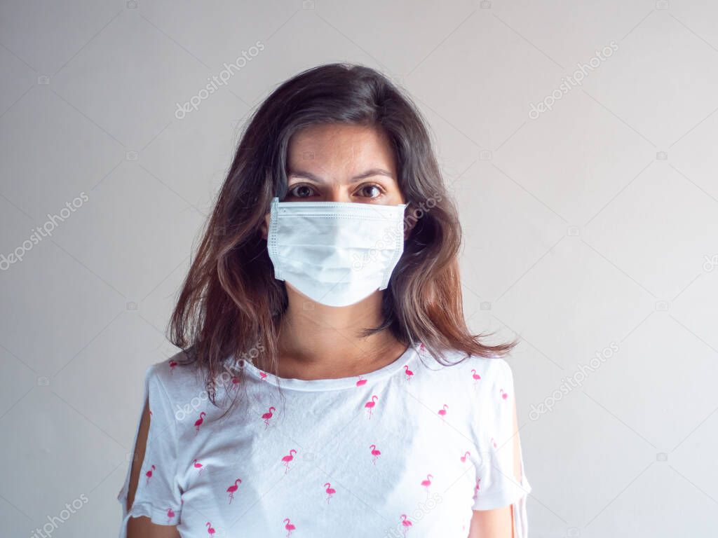 Young Attractive Brown Hair Hispanic/Latin Woman Using Disposable Face Mask for Cough, Flu, Virus, Viral Protection