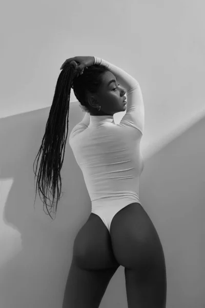 African woman portrait in white underwear on white background. Fashion beauty girl model in lingerie in studio