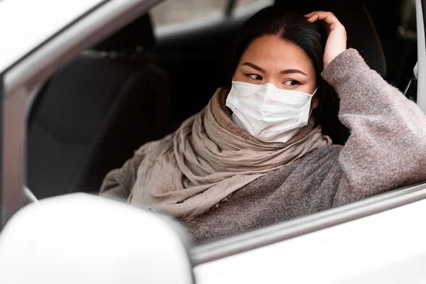 Woman protective mask driving car. Healthcare, virus protection. Taxi driver woman in mask