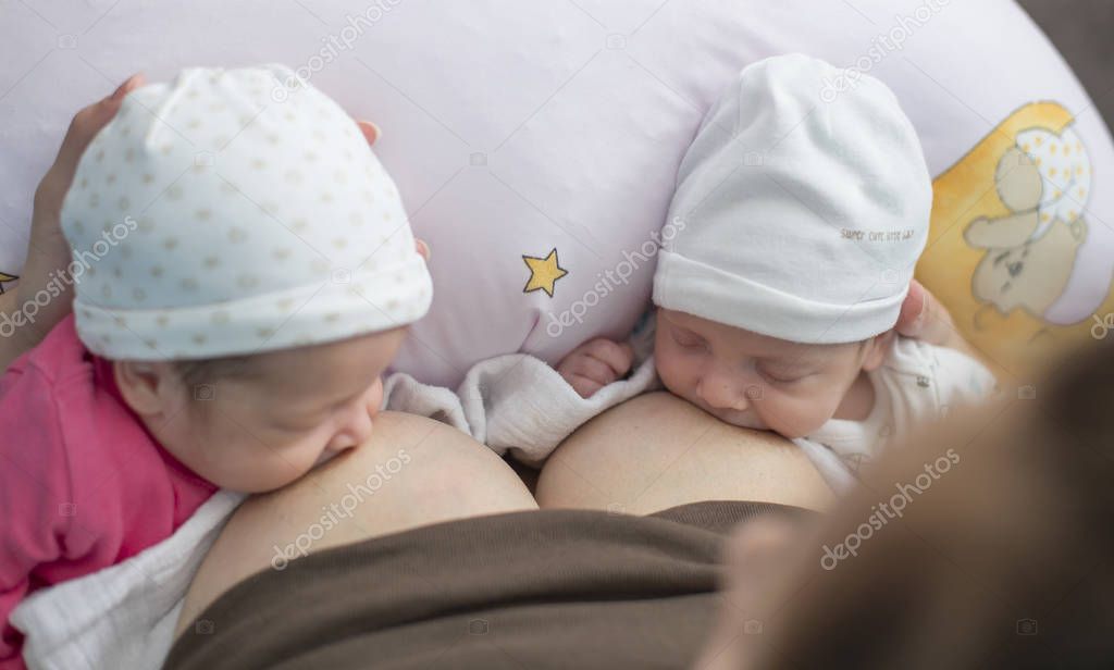 Breastfeeding twin babies — Stock Photo © Ondrooo #129848604
