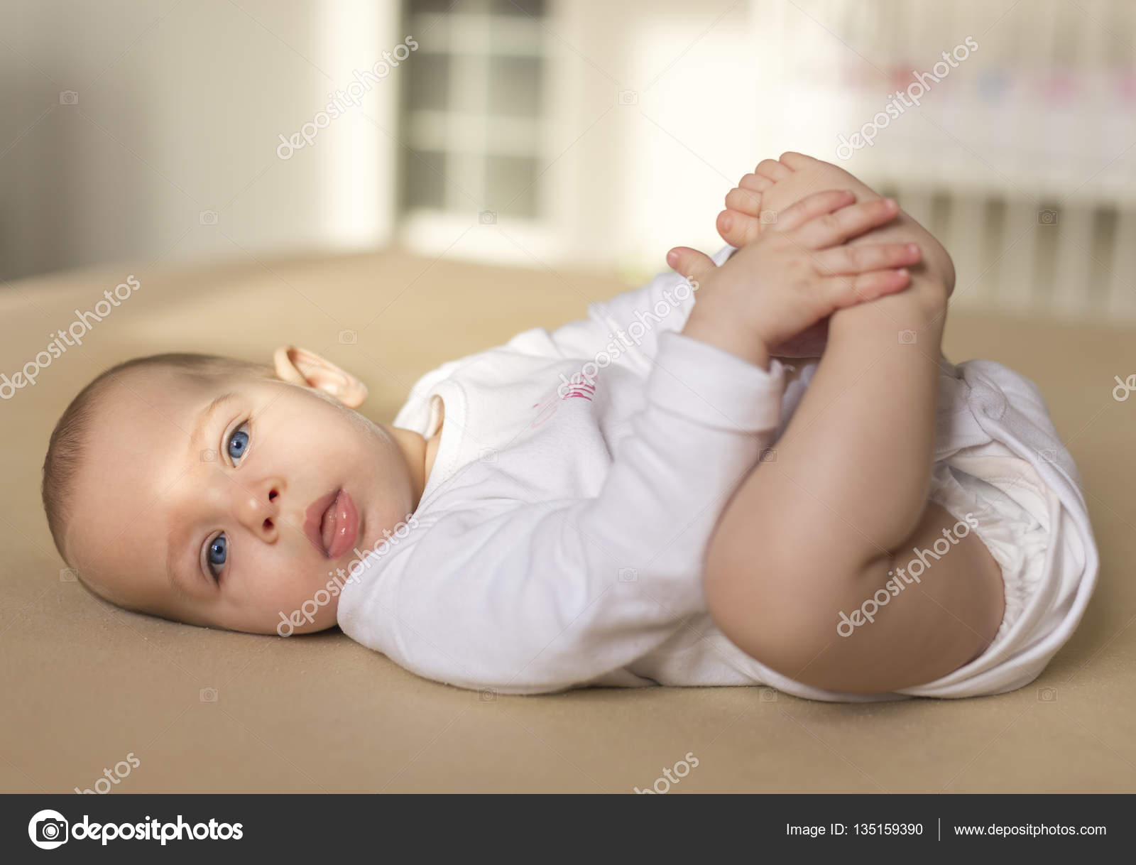 Happy baby playing with feet — Stock Photo © Ondrooo #135159390