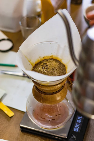 Alternating filter manual brewing of coffee close up. Devices for coffee in the background