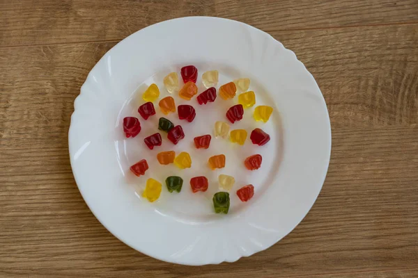 Delicious Jelly Bears on white plate top view — Stock Photo, Image