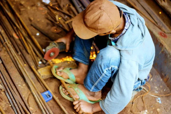Close-up view of cutting steel shape, huge amount of sparks. Angle grinder sparks angle grinder cutting steel. Cutting steel with angle grinder. Worker cutting metal.