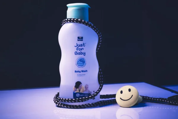 Dhaka,Bangladesh-February 26,2020 : Baby oil moisturizer cream for whole body with a happy smile.