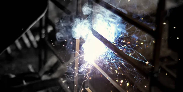 Metal welding. Sparks from electric heating. Iron, materials.Artistic welding sparks light, industrial background .