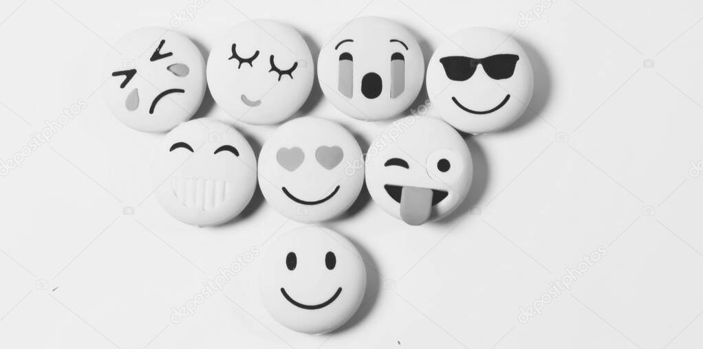 Yellow color various emotions emoji on a black and white background with selected focus on object .