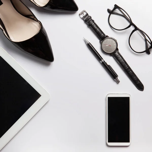 Business woman\'s set of office objects. Flatlay black and white background