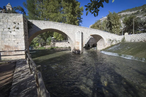 Puente romano, situado en la parte central de la ciudad, a su paso por el río Jucar, en la cima de la piedra caliza de montaña se encuentra el castillo de origen almohade del siglo XII, Alcalá del Jucar, España —  Fotos de Stock