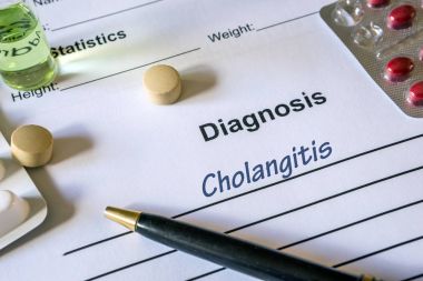 Diagnosis cholangitis written in the diagnostic form and pills clipart