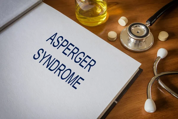 Aspergerův syndrom napsané na knihu s tablety. Koncepce přípravek — Stock fotografie