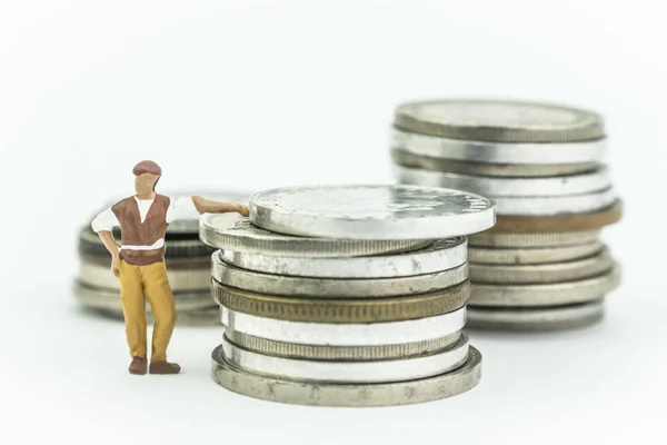 Miniature man next to a few coins, concept economy — Stock Photo, Image