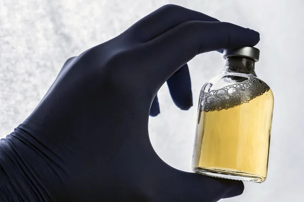 Detail of hand medical holding a vial, conceptual image — Stock Photo, Image