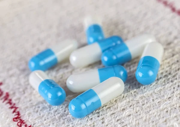 Some blue Pills Wrapped In Gauze — Stock Photo, Image